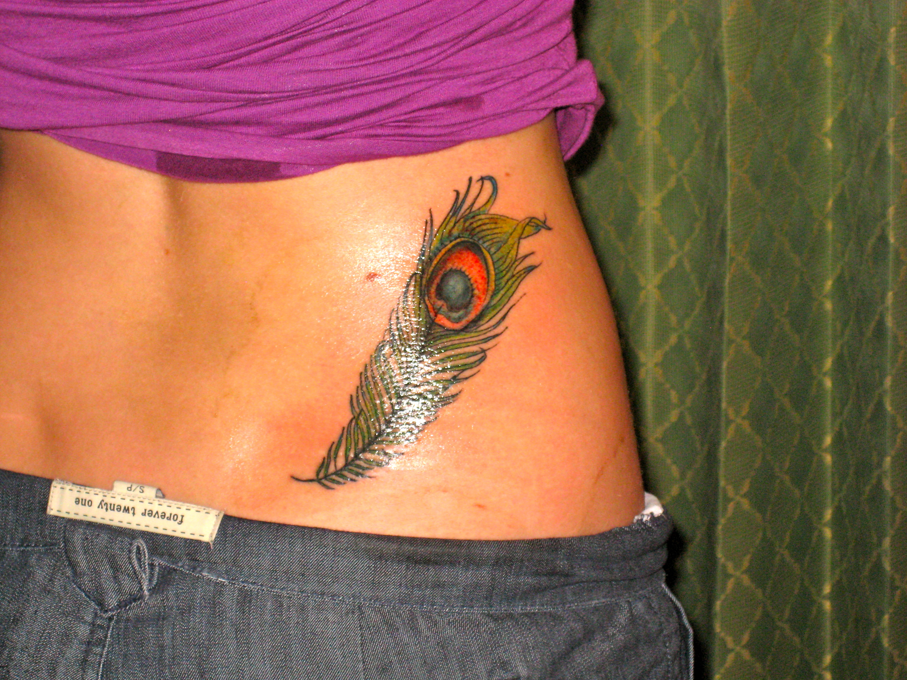 Peafowl tattoo on the arm - Tattoogrid.net